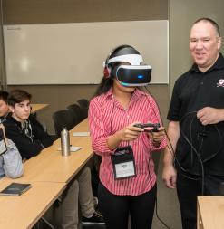 A student wears a VR headset during a demonstration.